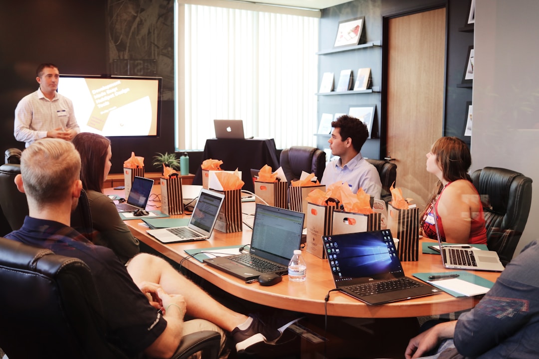 Boardroom scene with people engaged in a strategy meeting, representing a top proposal software program enabling data-driven analysis and informed decision making.